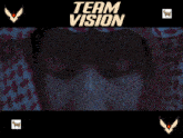 a man wearing a head scarf with the words team vision written above him