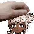 a hand is holding a girl 's head in front of her face .