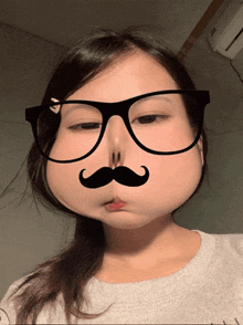 a girl wearing glasses and a fake mustache