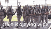 a group of soldiers marching in a parade with the words `` train is playing wipe '' on the bottom .