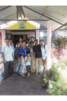 a group of people are posing for a picture in front of a building with a sign that says ' swami '