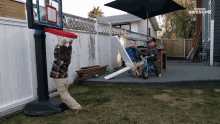 a basketball hoop in a backyard with the words awesome on the bottom