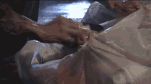 a person is laying in a plastic bag in the dark .