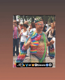 a man wearing a rainbow colored outfit and a crown stands in front of a crowd