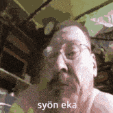 a pixelated image of a man with glasses and the words syon eka written on the bottom