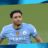 a soccer player wearing a shirt that says etihad