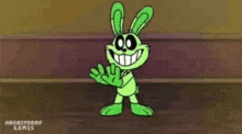 a green cartoon rabbit is standing on a wooden floor waving .