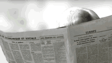 a person is reading a newspaper that says europe