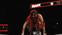 a woman in a wrestling ring with the word raw on the bottom