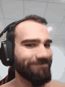 a man with a beard is wearing headphones