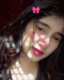 a girl with a pink bow on her hair