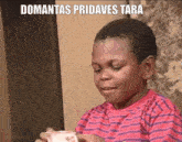 a young boy in a red and blue striped shirt is holding a cup with the words domantas pridaves tara written on it