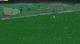 a soccer player is kicking a ball on a soccer field in a video game .