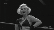 a black and white photo of a woman with a aew logo on the bottom