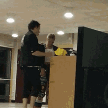 a man and a woman are standing in front of a podium with a yellow flower on it