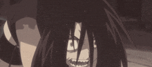 a close up of a person 's face with long black hair