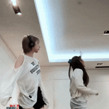 two girls wearing headphones and a shirt that says " try authentic "