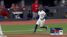 a blue jays player runs to first base during a baseball game