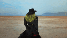 a woman with green hair is riding a horse