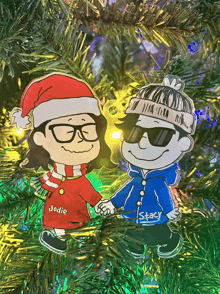 a christmas ornament of jodie and stacy holding hands on a christmas tree