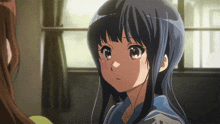 a girl with long black hair and a blue shirt is looking at another girl