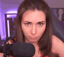 a woman sitting in a chair with a microphone and headphones