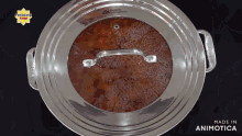a pan with a lid that says made in animotica