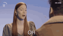 a woman says oh in front of a man