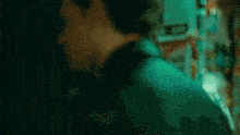 a man and a woman are standing next to each other in a dark room