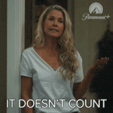 a woman standing in front of a door with the words it does n't count below her