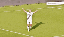 a soccer player celebrates a goal with her arms in the air while wearing a shirt that says bavaria