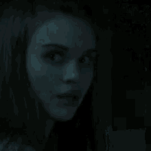 a dark room with a window with a light coming through it