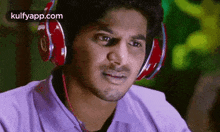 a man wearing headphones is looking at the camera .