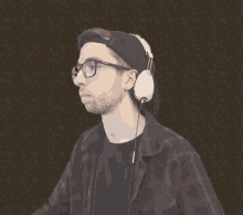 a man wearing glasses and headphones is standing in front of a dark background .