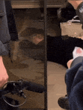 a person laying on the floor in front of a mirror with a microphone