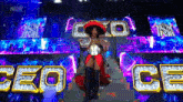 a woman in a red dress and sombrero is sitting on a stage holding a wrestling championship belt .