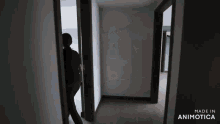 a person is standing in a hallway with the words made in animotica on the bottom