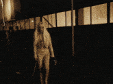 a woman with white hair is walking down a street