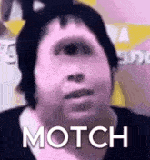 a close up of a person 's face with the words `` motch '' written on it .