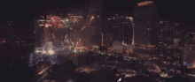 a fireworks display in front of a large building that says mgm