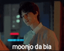 a man is standing in front of a sign that says moonjo da bia on it