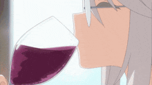 a person with glasses is drinking a glass of purple liquid