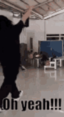 a woman is dancing in a room with the words oh yeah !! written on the floor .