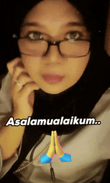 a woman wearing glasses and a hijab with the words assalamualaikum