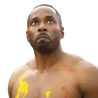 a shirtless man with yellow paint on his chest looks up at the sky