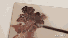 a palette with a brush on it that says made in animotica on the bottom