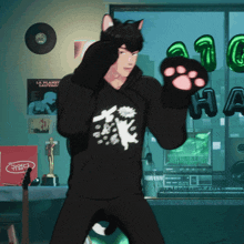 a man wearing a black hoodie with a cat on it
