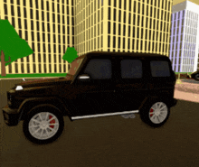 a black car with white wheels is parked in front of a building