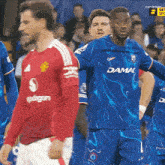 a soccer player wearing a blue jersey that says damac