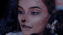 a close up of a woman 's face with cat makeup